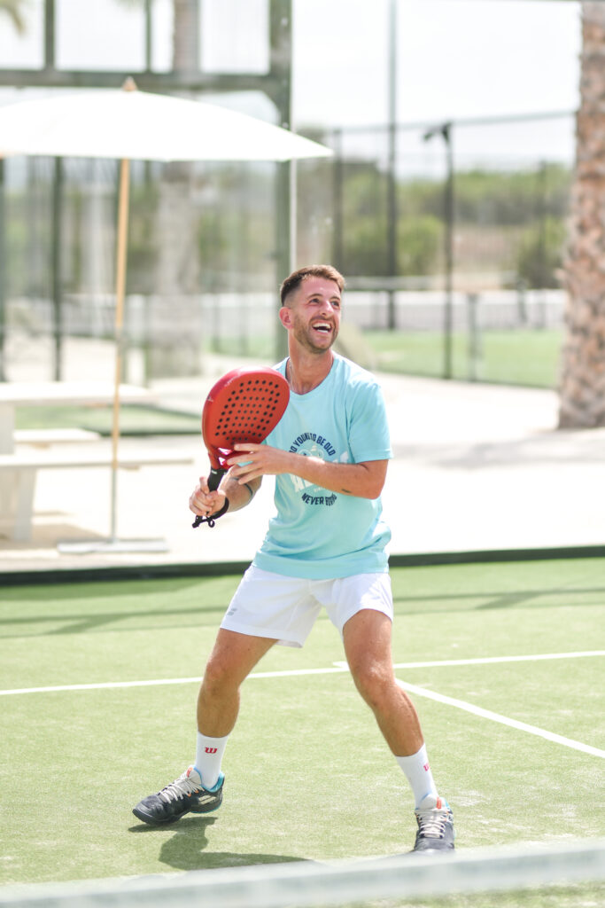 Padel tennis player serving in Ibiza
